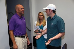 Michelle & Igor Present Mike Dee With $1000 For The Miami Dolphins Foundation